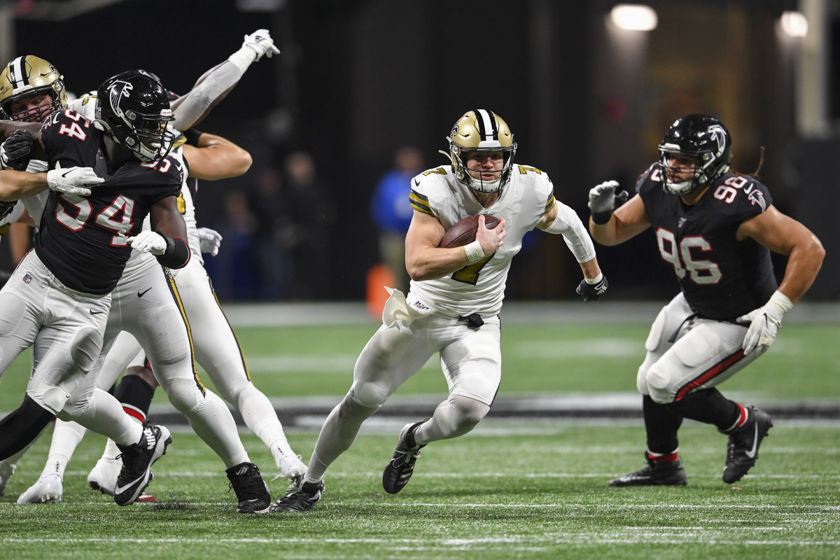 Nov 28, 2019; Atlanta, GA, USA; New Orleans Saints quarterback Taysom Hill (7) runs through the Atlanta Falcons defense for a touchdown during the first half at Mercedes-Benz Stadium. Mandatory Credit: D